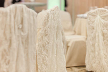 Decoration of chairs at the wedding. Beautiful chairs with decorationsの写真素材