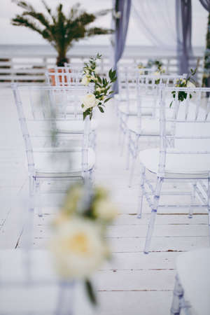 Decoration of chairs at the wedding. Beautiful chairs with decorationsの写真素材