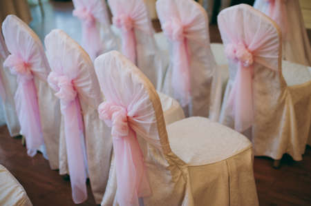 Decoration of chairs at the wedding. Beautiful chairs with decorationsの写真素材