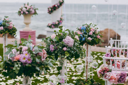 Original wedding floral decoration in the form of mini-vases and bouquets of flowers hanging from the ceilingの写真素材