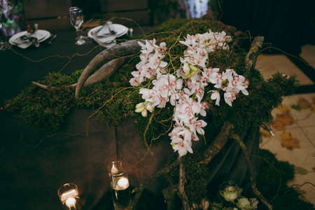 Original wedding floral decoration in the form of mini-vases and bouquets of flowers hanging from the ceilingの写真素材