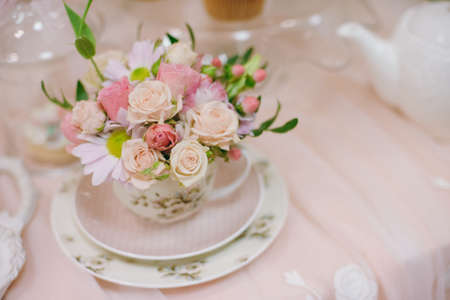 Original wedding floral decoration in the form of mini-vases and bouquets of flowers hanging from...