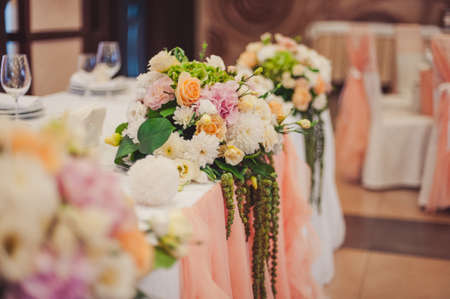 Original wedding floral decoration in the form of mini-vases and bouquets of flowers hanging from the ceilingの写真素材