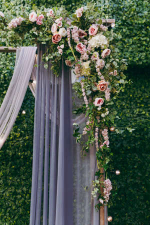 Original wedding floral decoration in the form of mini-vases and bouquets of flowers hanging from the ceilingの写真素材