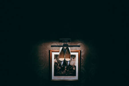 Bride wedding shoes with high heels and silver brilliant earrings on sheep's clothingの写真素材