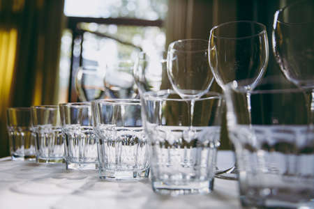 Many glasses on a table with alcohol and withoutの写真素材