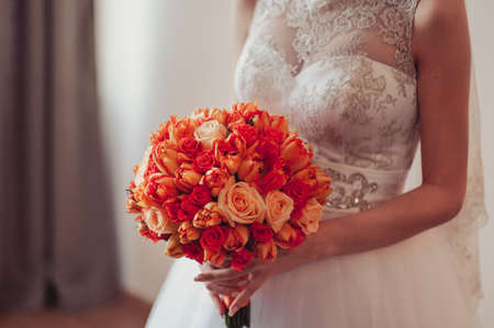Bride holding big wedding bouquet on wedding ceremonyの写真素材