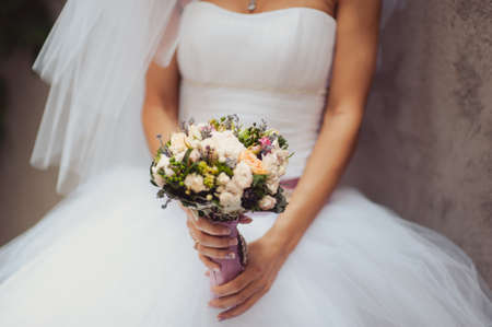 Bride holding big wedding bouquet on wedding ceremonyの写真素材