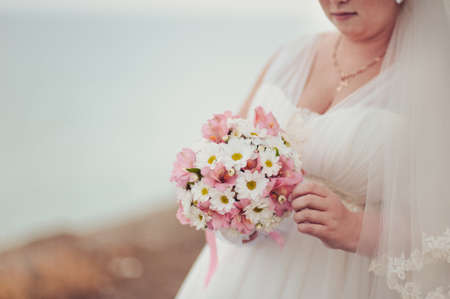 Bride holding big wedding bouquet on wedding ceremonyの写真素材