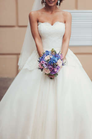 Bride holding big wedding bouquet on wedding ceremonyの写真素材