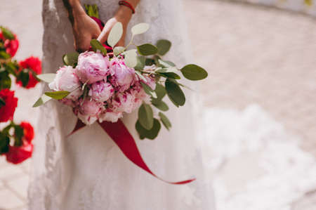 Bride holding big wedding bouquet on wedding ceremonyの写真素材