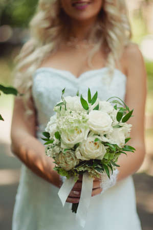 Bride holding big wedding bouquet on wedding ceremonyの写真素材