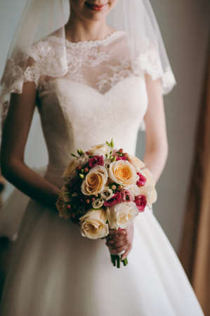 Bride holding big wedding bouquet on wedding ceremonyの写真素材