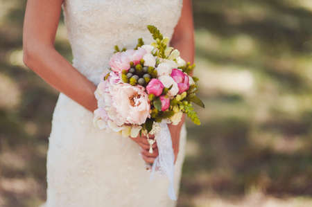 Bride holding big wedding bouquet on wedding ceremonyの写真素材