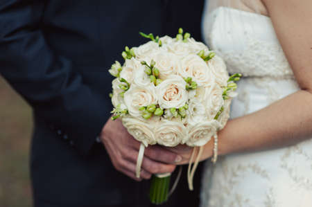 Bride holding big wedding bouquet on wedding ceremonyの写真素材