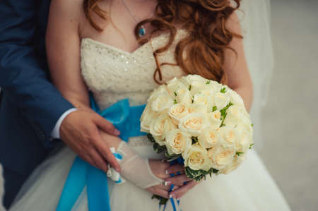 Bride holding big wedding bouquet on wedding ceremonyの写真素材