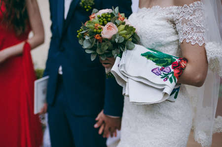 Bride holding big wedding bouquet on wedding ceremonyの写真素材