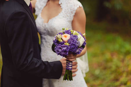 Bride holding big wedding bouquet on wedding ceremonyの写真素材