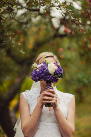 Bride holding big wedding bouquet on wedding ceremonyの写真素材