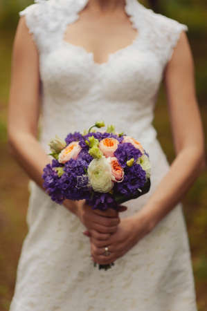 Bride holding big wedding bouquet on wedding ceremonyの写真素材