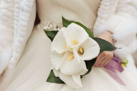 Bride holding big wedding bouquet on wedding ceremonyの写真素材