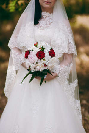 Bride holding big wedding bouquet on wedding ceremonyの写真素材