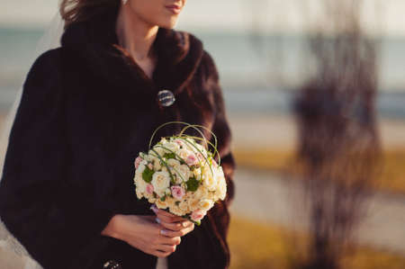 Bride holding big wedding bouquet on wedding ceremonyの写真素材