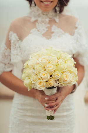 Bride holding big wedding bouquet on wedding ceremonyの写真素材