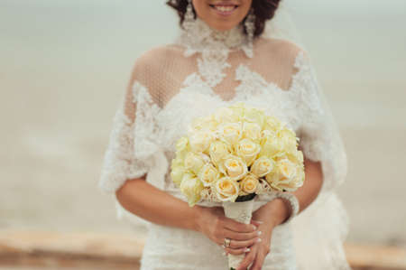 Bride holding big wedding bouquet on wedding ceremonyの写真素材