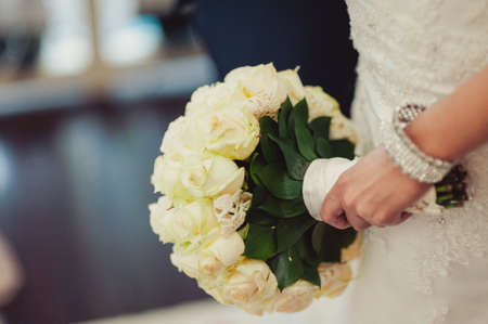 Bride holding big wedding bouquet on wedding ceremonyの写真素材