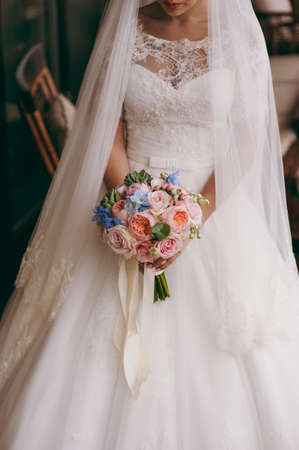 Bride holding big wedding bouquet on wedding ceremonyの写真素材