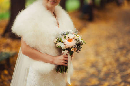 Bride holding big wedding bouquet on wedding ceremonyの写真素材