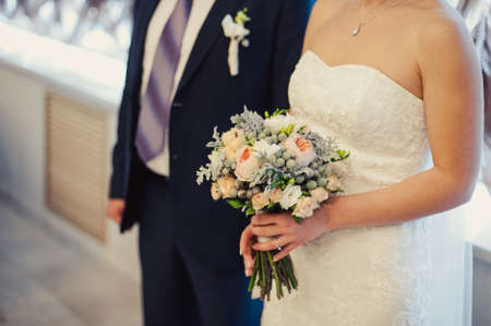 Bride holding big wedding bouquet on wedding ceremonyの写真素材