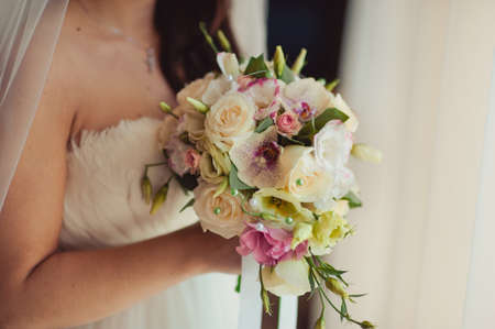 Bride holding big wedding bouquet on wedding ceremonyの写真素材