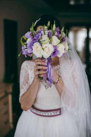 Bride holding big wedding bouquet on wedding ceremonyの写真素材