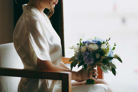 Bride holding big wedding bouquet on wedding ceremonyの写真素材