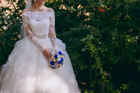 Bride holding big wedding bouquet on wedding ceremonyの写真素材