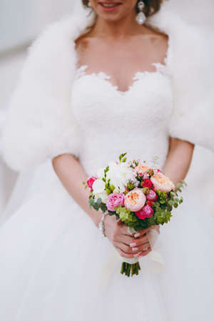 Bride holding big wedding bouquet on wedding ceremonyの写真素材