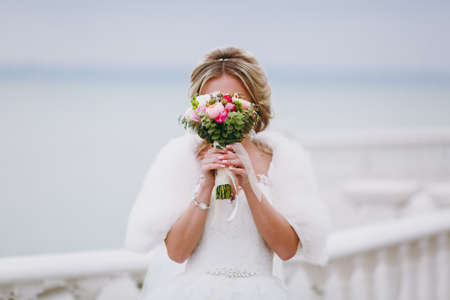 Bride holding big wedding bouquet on wedding ceremonyの写真素材