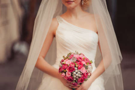 Bride holding big wedding bouquet on wedding ceremonyの写真素材