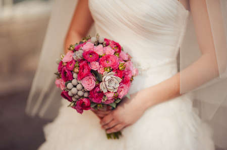 Bride holding big wedding bouquet on wedding ceremonyの写真素材