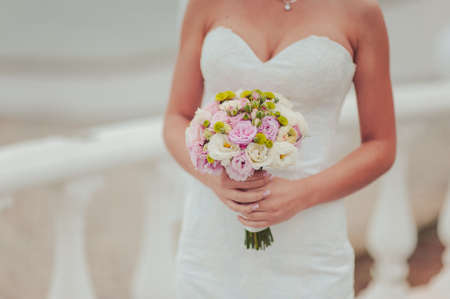 Bride holding big wedding bouquet on wedding ceremonyの写真素材