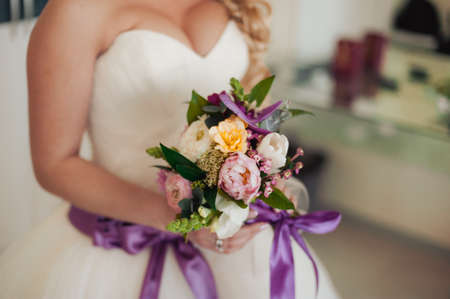Bride holding big wedding bouquet on wedding ceremonyの写真素材