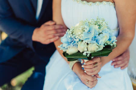 Bride holding big wedding bouquet on wedding ceremonyの写真素材