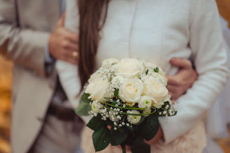 Bride holding big wedding bouquet on wedding ceremonyの写真素材