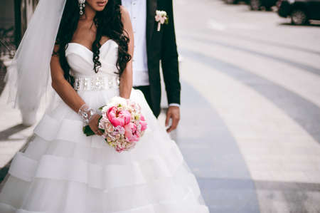 Bride holding big wedding bouquet on wedding ceremonyの写真素材