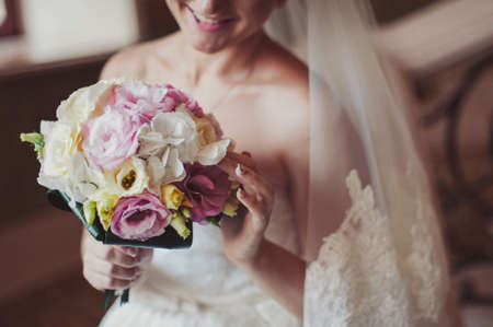 Bride holding big wedding bouquet on wedding ceremony