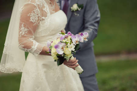 Bride holding big wedding bouquet on wedding ceremonyの写真素材