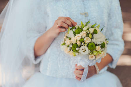 Bride holding big wedding bouquet on wedding ceremonyの写真素材