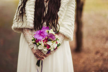 Bride holding big wedding bouquet on wedding ceremonyの写真素材